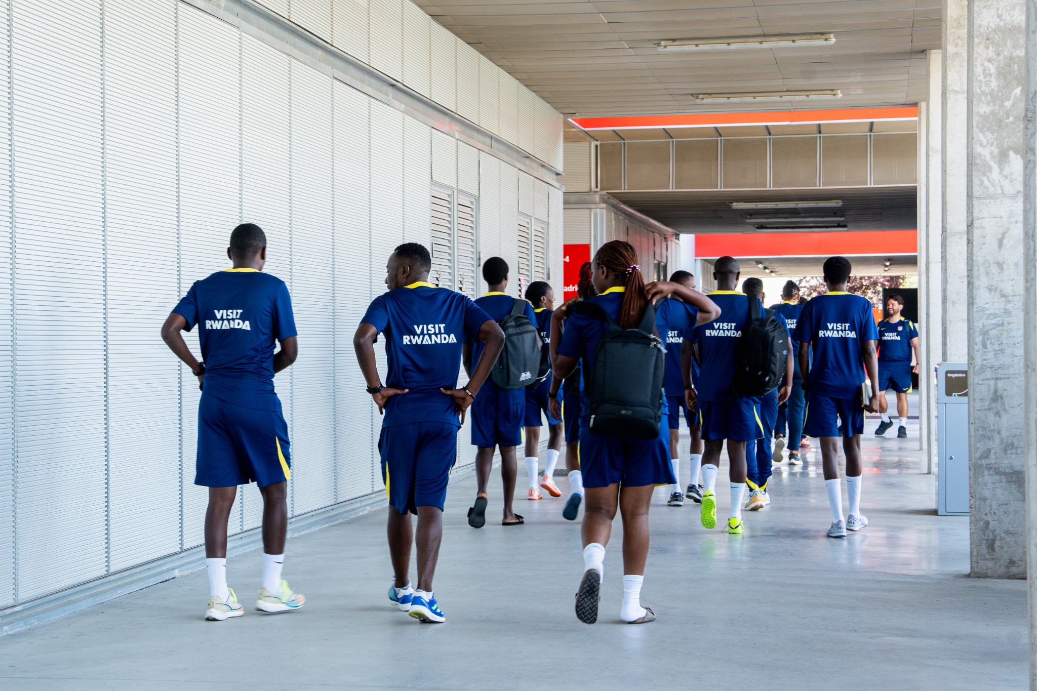 A visiting coach-experience group walking through the club facilities